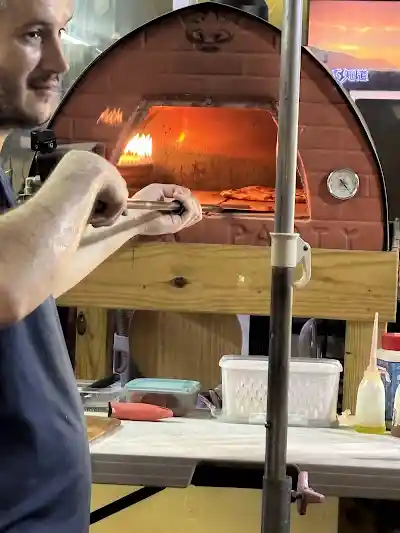 Hand-shaping the pizza dough